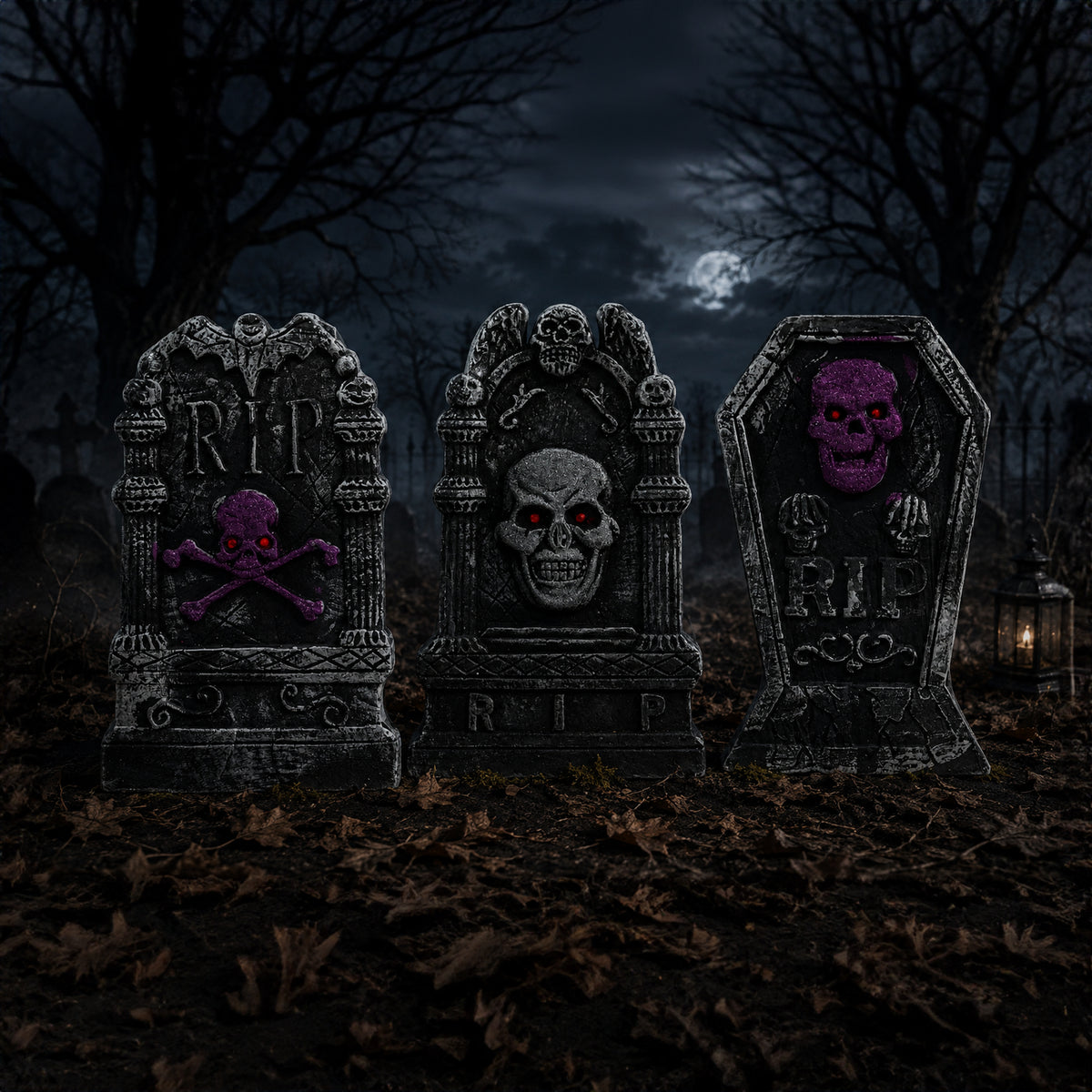 Three Halloween tombstone decorations standing in a dark, leaf-covered yard at night under a full moon and bare trees. The tombstones are gray with carved skull and crossbones details, and the center and right tombstones feature glowing purple skull faces.