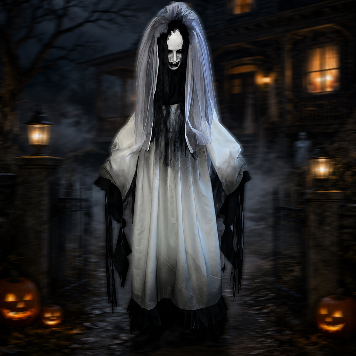 A ghostly Halloween costume featuring a long white dress with black tattered sleeves and hem, a black face mask with white eyes and a wide grin, and a long white veil, shown standing in a spooky haunted house yard at night with pumpkins.