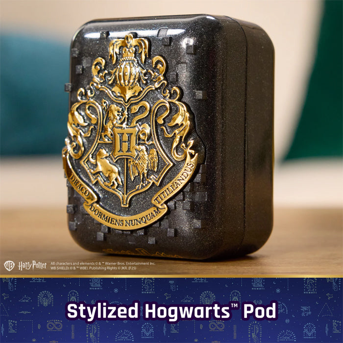 Stylized Hogwarts™ Pod with gold crest on a wooden surface