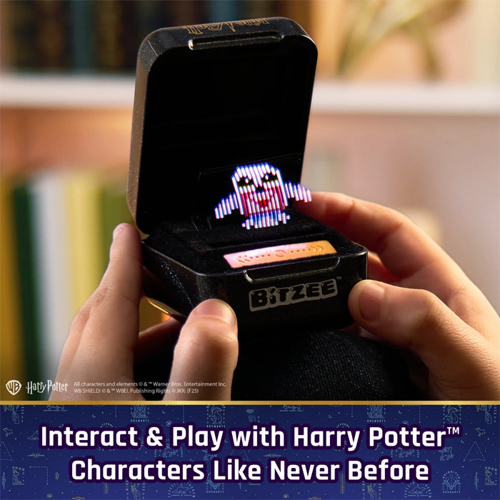 Hand holding a small electronic device displaying a character, with 'BITZEE' branding and 'Harry Potter' theme.