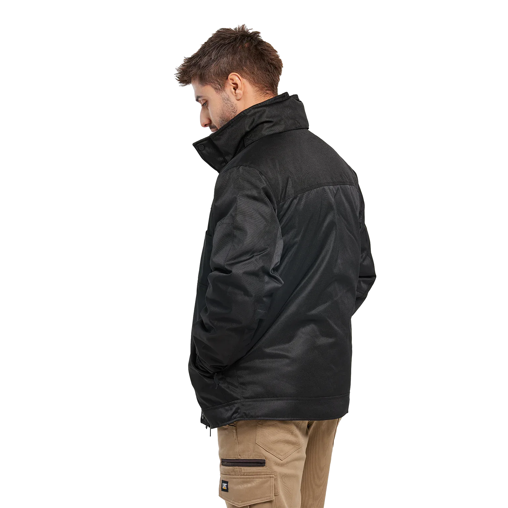 A man shown from the side profile wearing a black puffer jacket and tan cargo pants against a solid white background.