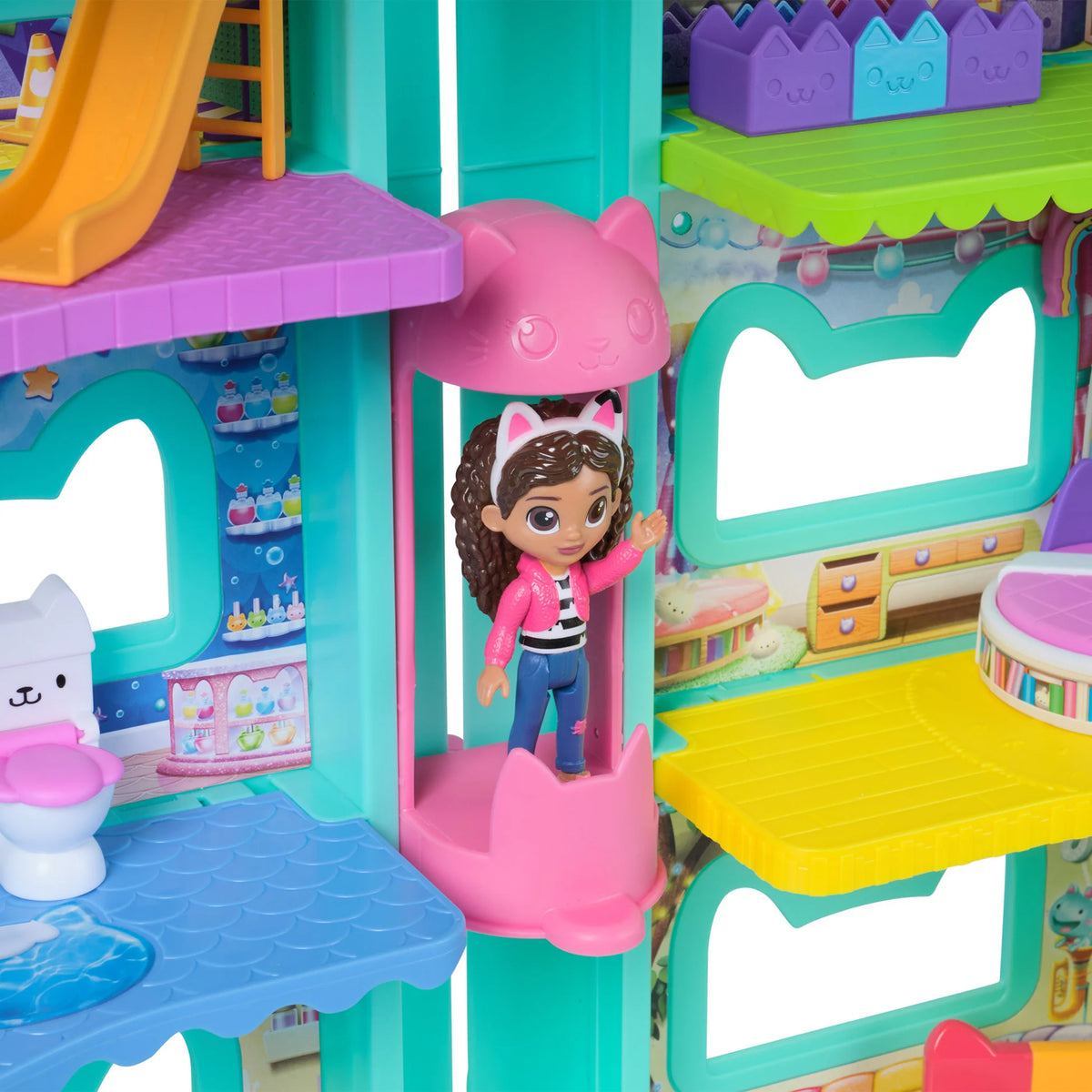 Colorful toy playset with a doll inside a pink cat-themed structure.